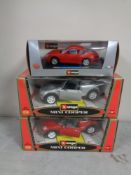 Three boxed Burago die cast cars, Porsche 911 and two Mini Coopers.