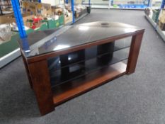 A contemporary black glass and wood framed TV stand