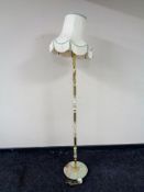 A gilt brass and onyx standard lamp