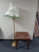 A contemporary square coffee table together with a brass table lamp with shade