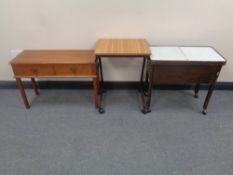 A 20th century sewing trolley together with a bed table and a further side table fitted two drawers