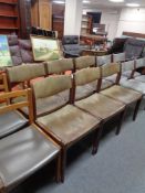 A set of six mid 20th century Danish beech dining chairs upholstered in a green leather