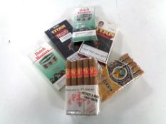 A tray containing six packets of sealed cigars