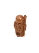 A carved hardwood Chinese netsuke - Man holding a staff