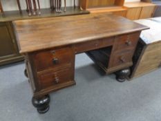 A continental oak five drawer chest on bulbous legs with carved and inlaid back