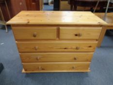 A contemporary pine five drawer chest