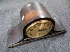 A 1930s oak cased mantel clock with silver dial.