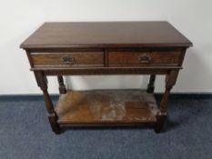 A contemporary oak two tier side table fitted two drawers
