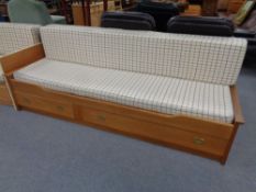 A 20th century pine pull out day bed fitted two drawers beneath
