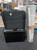 A three piece luggage case set together with a leather briefcase and two contemporary rugs
