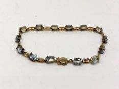 A 10ct gold blue topaz line bracelet, length 17cm. CONDITION REPORT: 3.7g.