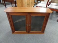 An antique mahogany double door glazed bookcase