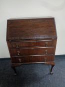 An Edwardian mahogany writing bureau on claw and ball feet