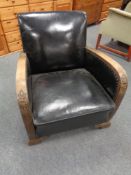 A wood framed Art Deco armchair upholstered in a black vinyl