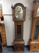 A contemporary longcase clock with brass moonphase dial
