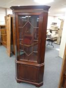 A mahogany astragal glazed corner cabinet fitted cupboard below