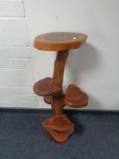 A rustic wooden five way plant stand