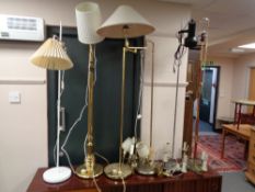 A collection of six continental floor and standard lamps together with two further brass light