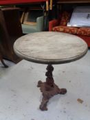 A circular bar table on a cast iron pedestal