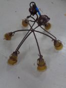 A contemporary metal six way light fitting with glass shades