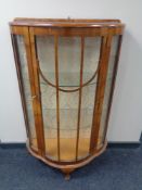 A 20th century walnut shaped front display cabinet
