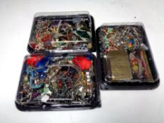 Three plastic lidded trays of costume jewellery and make up and Swarvoski piece