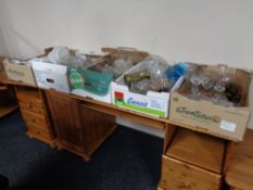 Five boxes containing assorted glassware, brass embossed jug,