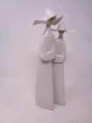 A Lladro figure of two nuns