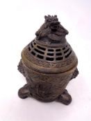 A Chinese embossed bronze incense pot with dragon design