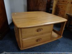 An Ercol elm Pandora's box coffee table on castors