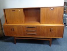A 20th century teak G-Plan cocktail sideboard on raised legs,