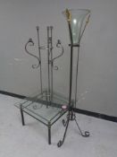 A contemporary square glass topped coffee table together with a vase on glass stand and a floor