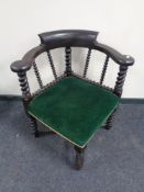A late 19th century oak corner smoker's armchair on barley twist legs