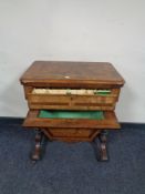 A Victorian mahogany and walnut work table with marquetry inlay fitted a drawer and basket beneath,