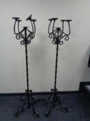 A pair of wrought iron floor standing five way candelabra