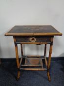 A ceramic elephant plant stand together with an early 20th century bamboo two tier occasional table,