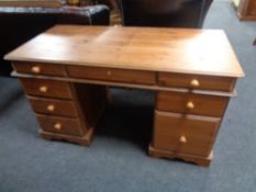 A contemporary pine computer desk fitted nine drawers