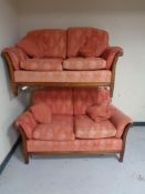 Two wood framed settees upholstered in a pink brocade fabric