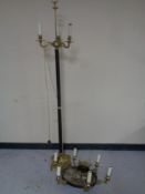 A continental brass and metal three way floor lamp together with a similar six way chandelier