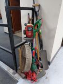 An electric strimmer together with a petrol hedge trimmer,