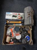 A box of circular drill disks together with a heavy duty metal toolbox and two tile cutters