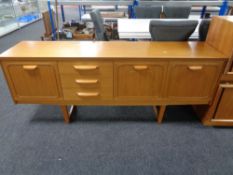 A 20th century teak effect low sideboard