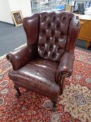 A Burgundy button leather Chesterfield wingback chair