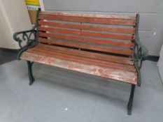 A cast iron wooden slatted garden bench