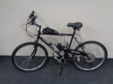 A mountain bike (shimano equipped) fitted with two stroke engine and petrol tank