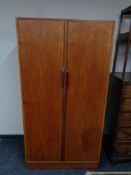 A mid 20th century teak double door wardrobe