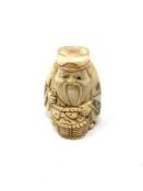 A carved Chinese bone netsuke - Gentleman holding a basket