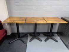 Three pine topped cast iron based cafe tables