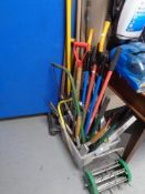 A plastic tub containing a large quantity of assorted garden tools, hand saws, spirit levels,