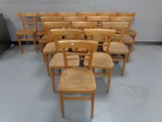 Sixteen wooden school chairs